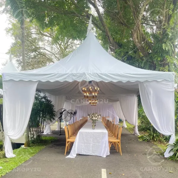 White pagoda canopy over a dining table in a garden