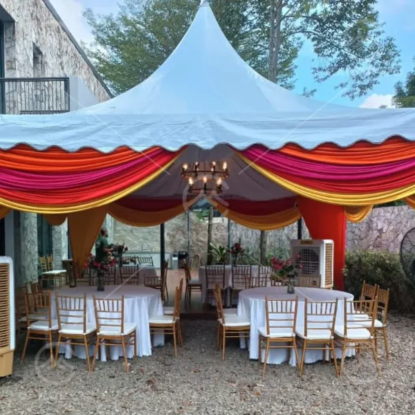 Pagoda canopy with red and gold draping over round tables